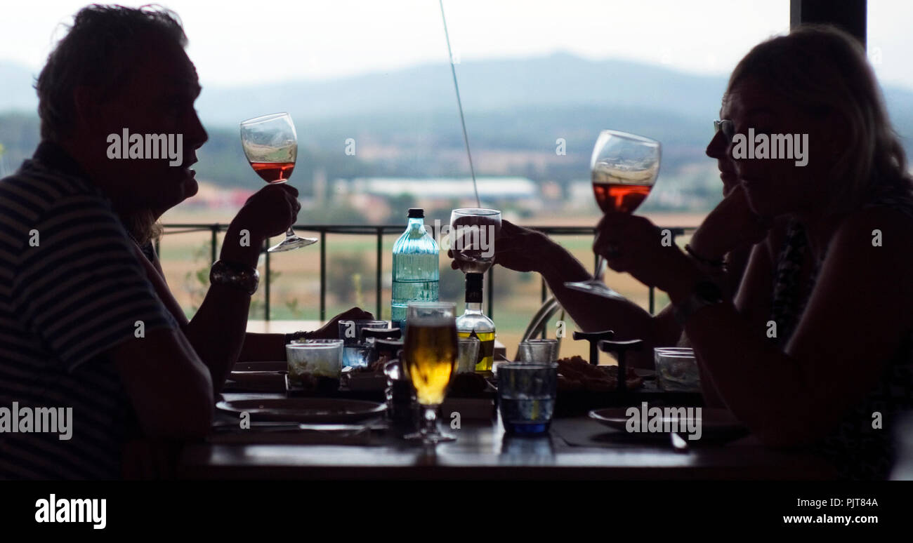 Tourists eat lunch at a restaurant overlooking the countryside near Girona, in Spain September 6, 2018. Stock Photo