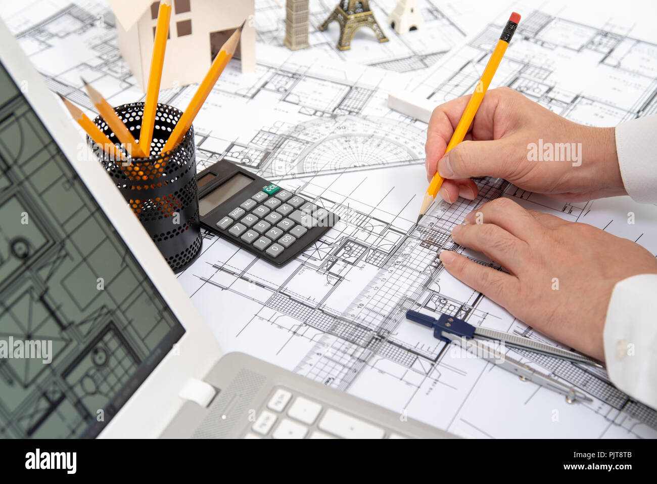 The hand of a male architect drawing a design using a pencil Stock ...