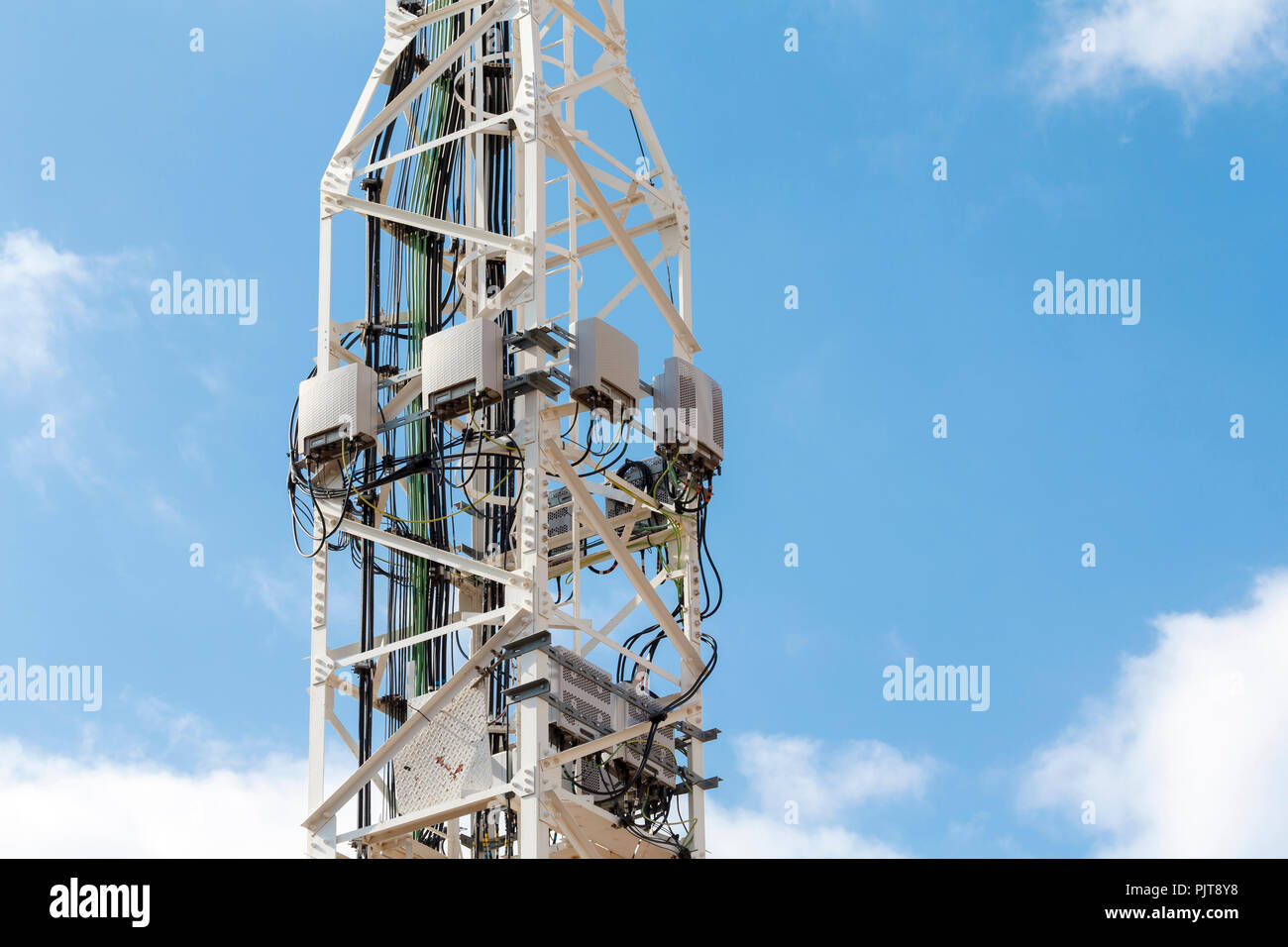 Telecommunications tower against blue sky. Stock Photo