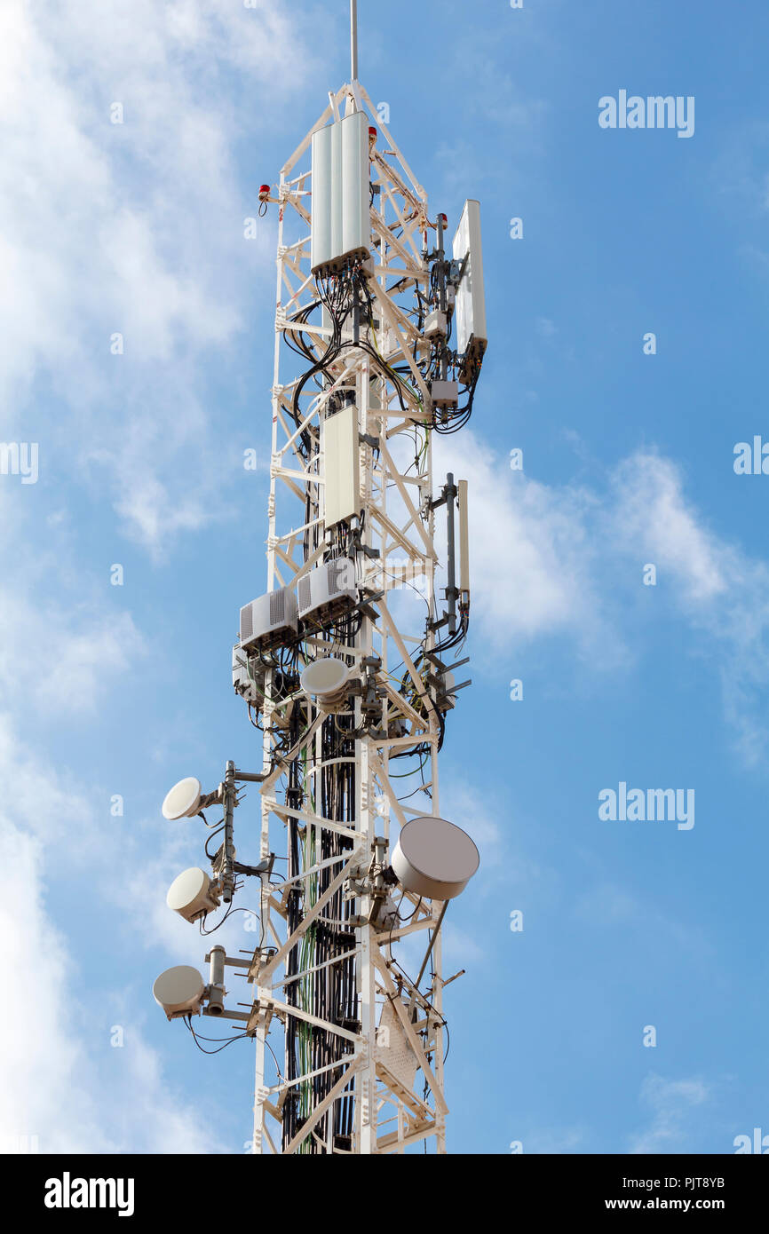 Telecommunications tower against blue sky. Stock Photo