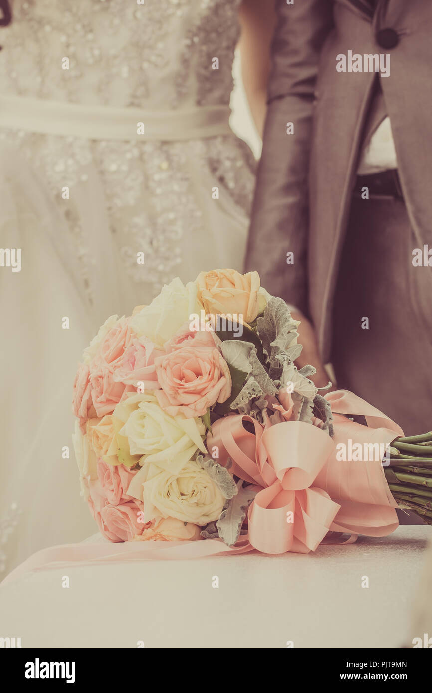 Bouquet and the couple who are married, vintage tone. Stock Photo