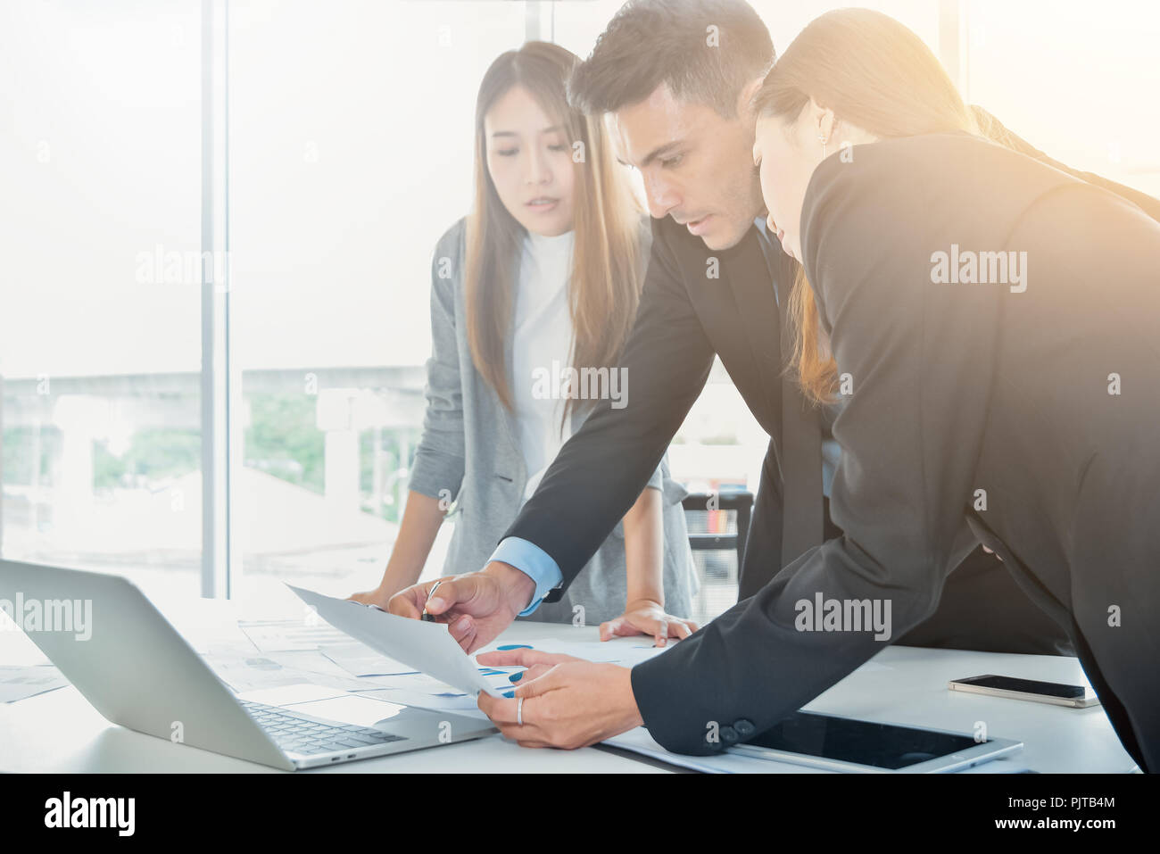 Business Team concept ,Business people brainstorm or discussing the document or finance report charts and graphs on office desk Stock Photo