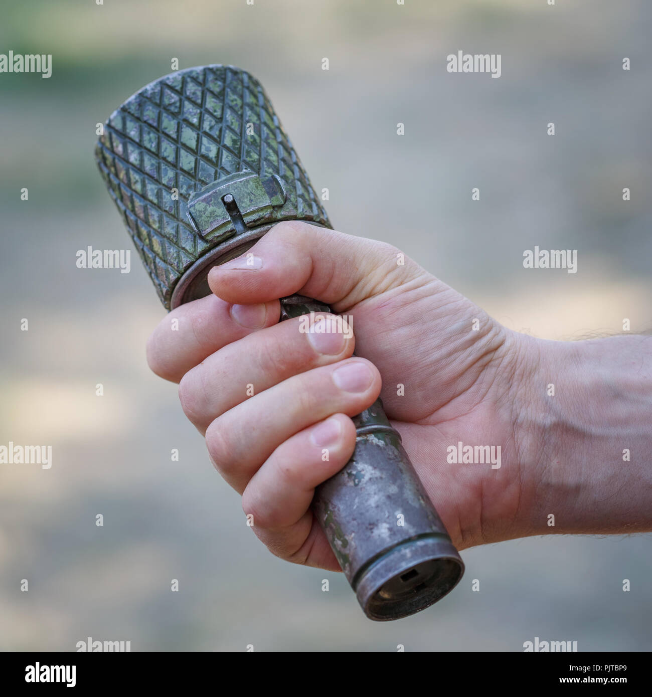 Antitank grenade in the male hand close-up Stock Photo