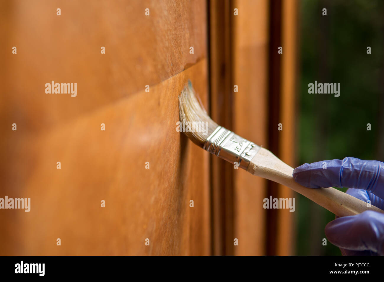 removing wax with a paintbrush as a part of restoration process of old