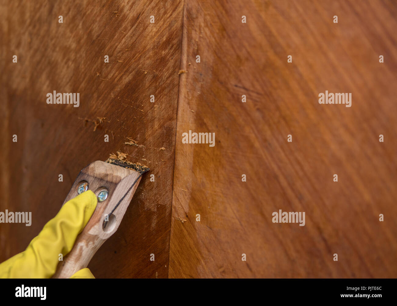 Scratching Old Wax With A Tool As A Part Of Restoration Process Of
