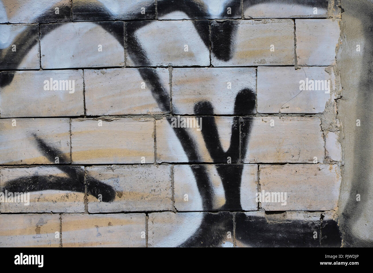 Texture of a fragment of the wall with graffiti painting, which is