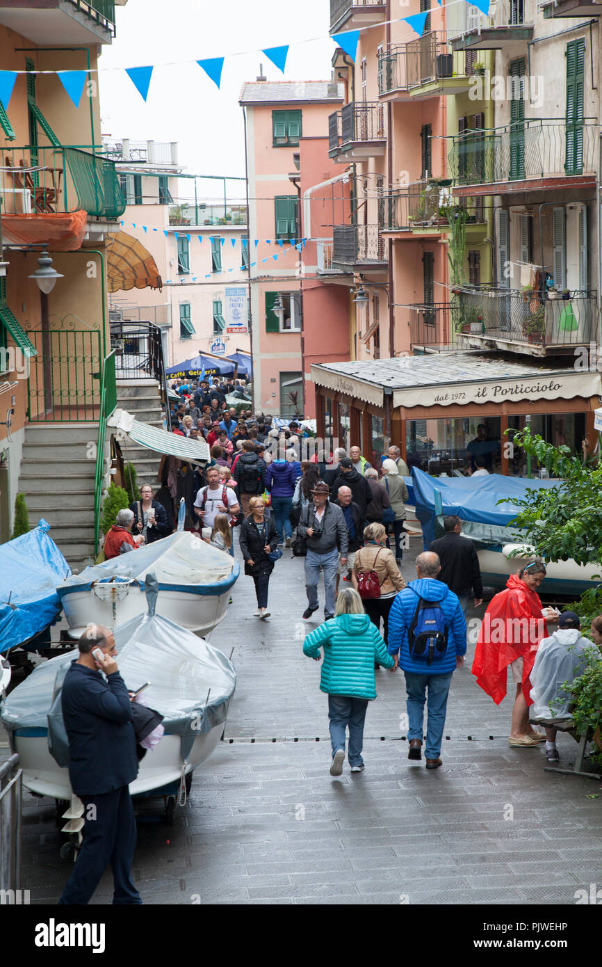 streets of Manarola, Italy crowded with tourists during the summer months Stock Photo