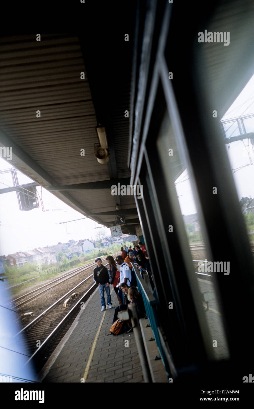 People waiting for the train on the platform of the Ghent Dampoort