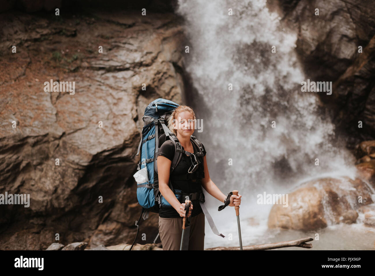 Hiker in front of waterfall, Annapurna Circuit, the Himalayas, Manang, Nepal Stock Photo