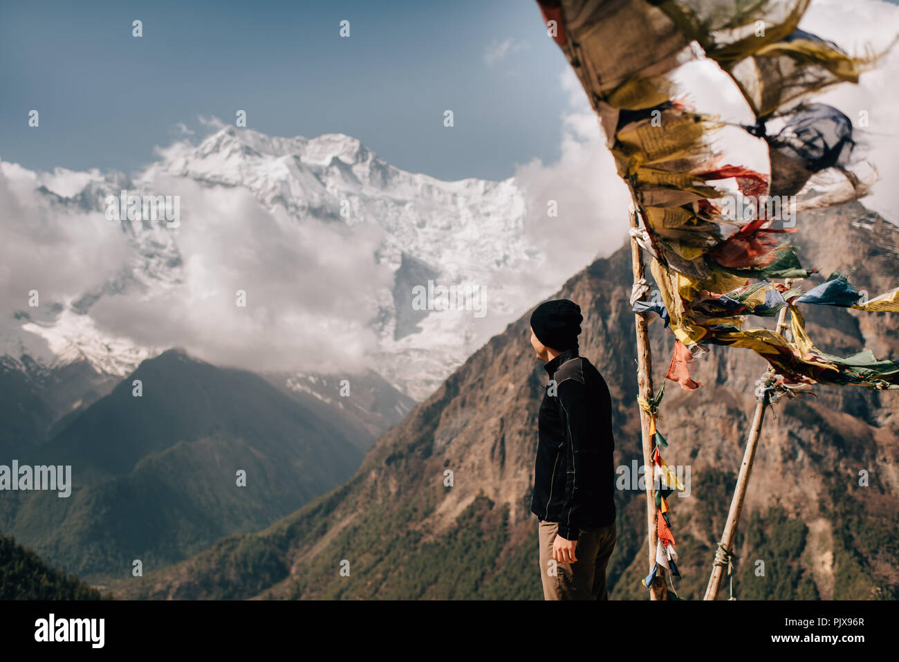 Hiker on peak, Annapurna Circuit,  view to Annapurna 2 mountain, the Himalayas, Manang, Nepal Stock Photo