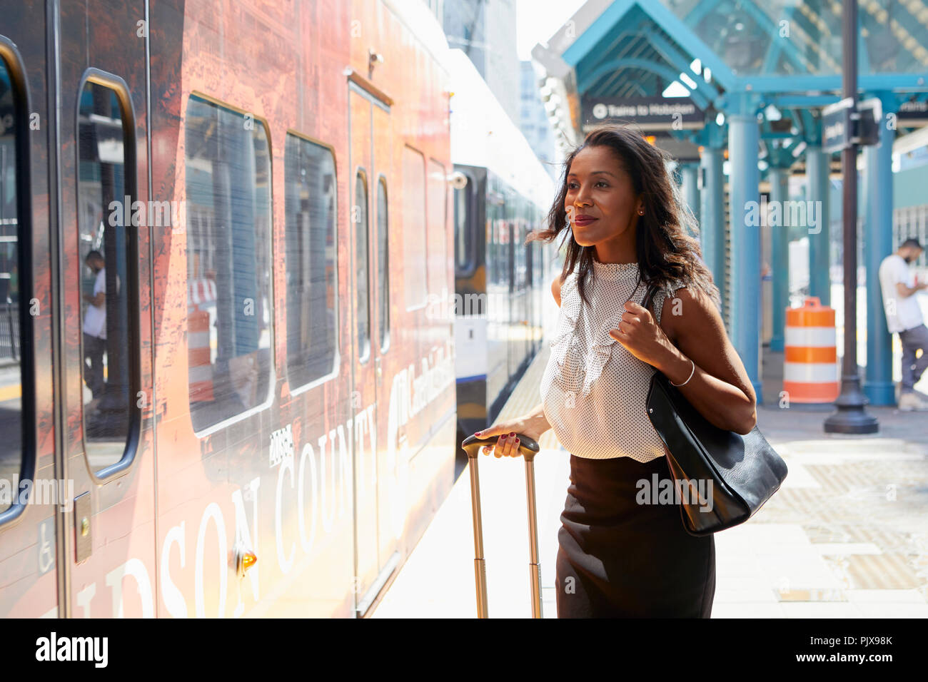 Woman boarding train hi-res stock photography and images - Alamy