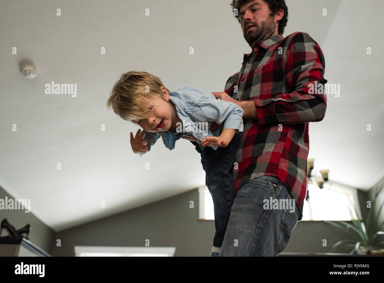 Father playing with son at home Stock Photo