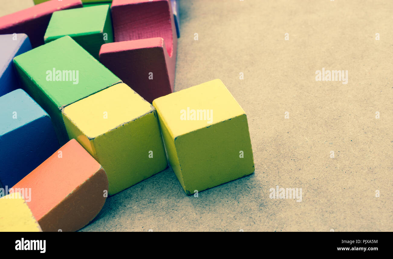 Colorful building blocks on a brown background Stock Photo - Alamy