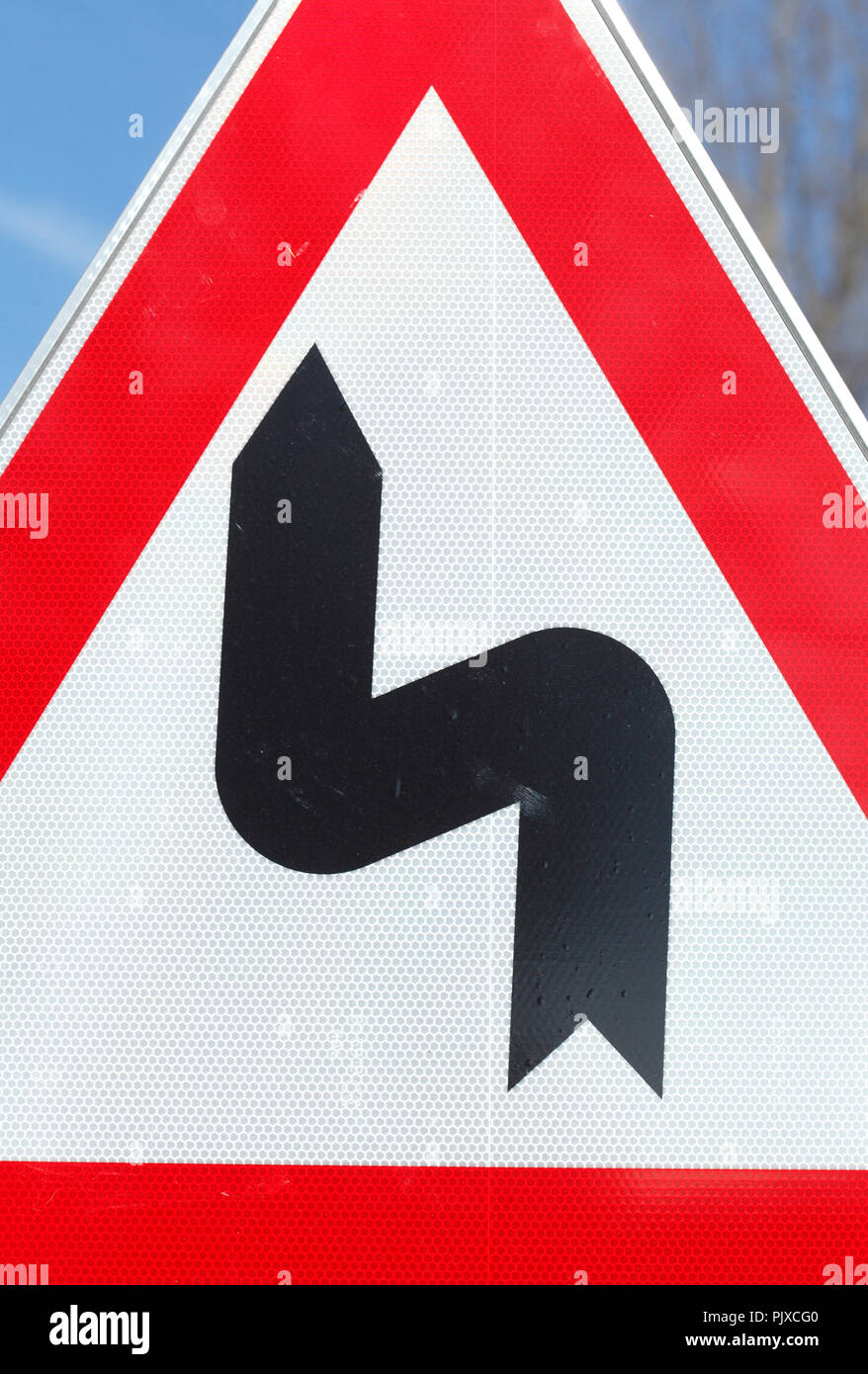 Road sign double turn first right Stock Photo