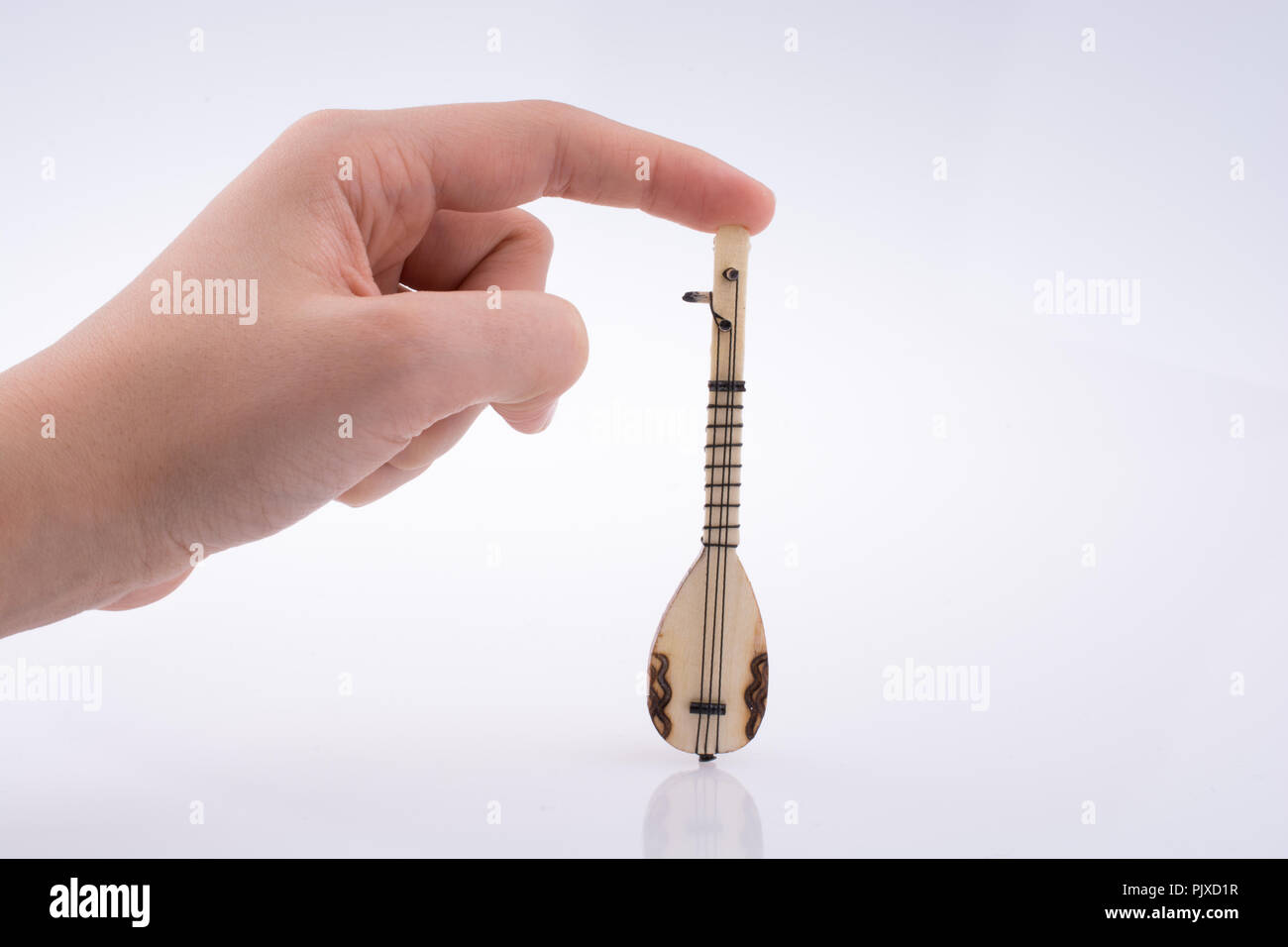 Hand Use Intument Hand holding turkish musical instrument saz on a white background Stock ...