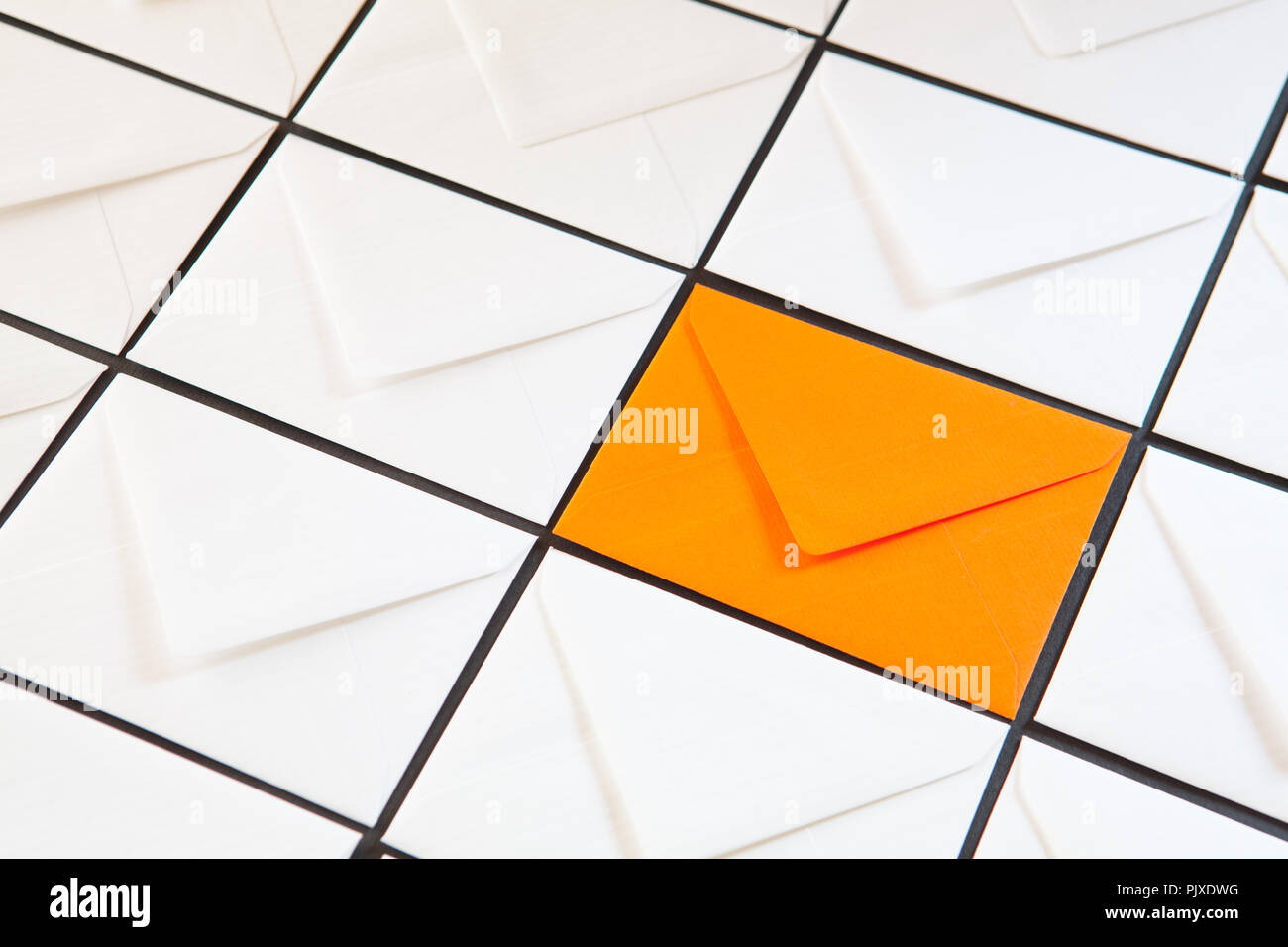 Composition with white and orange envelopes on the table. Different colored envelopes on the table. Stock Photo