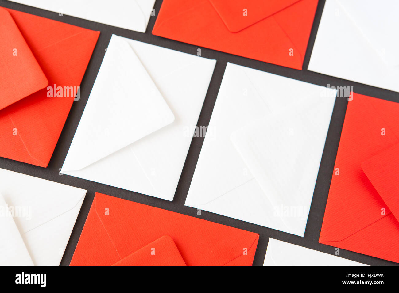 Composition with white and red  envelopes on the table. Different colored envelopes on the table. Stock Photo