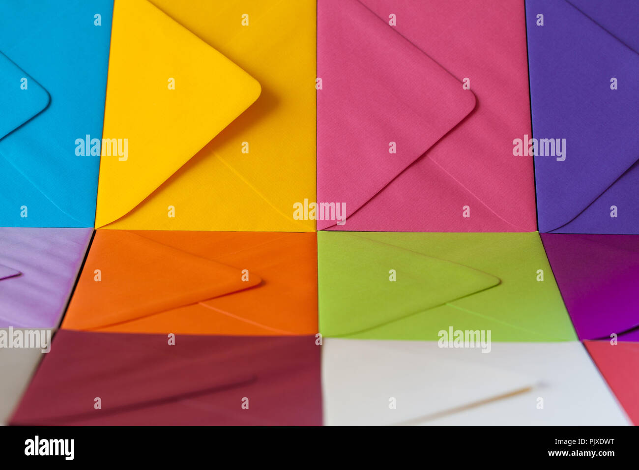Different colored envelopes on the table. Composition with envelopes on the table. Stock Photo
