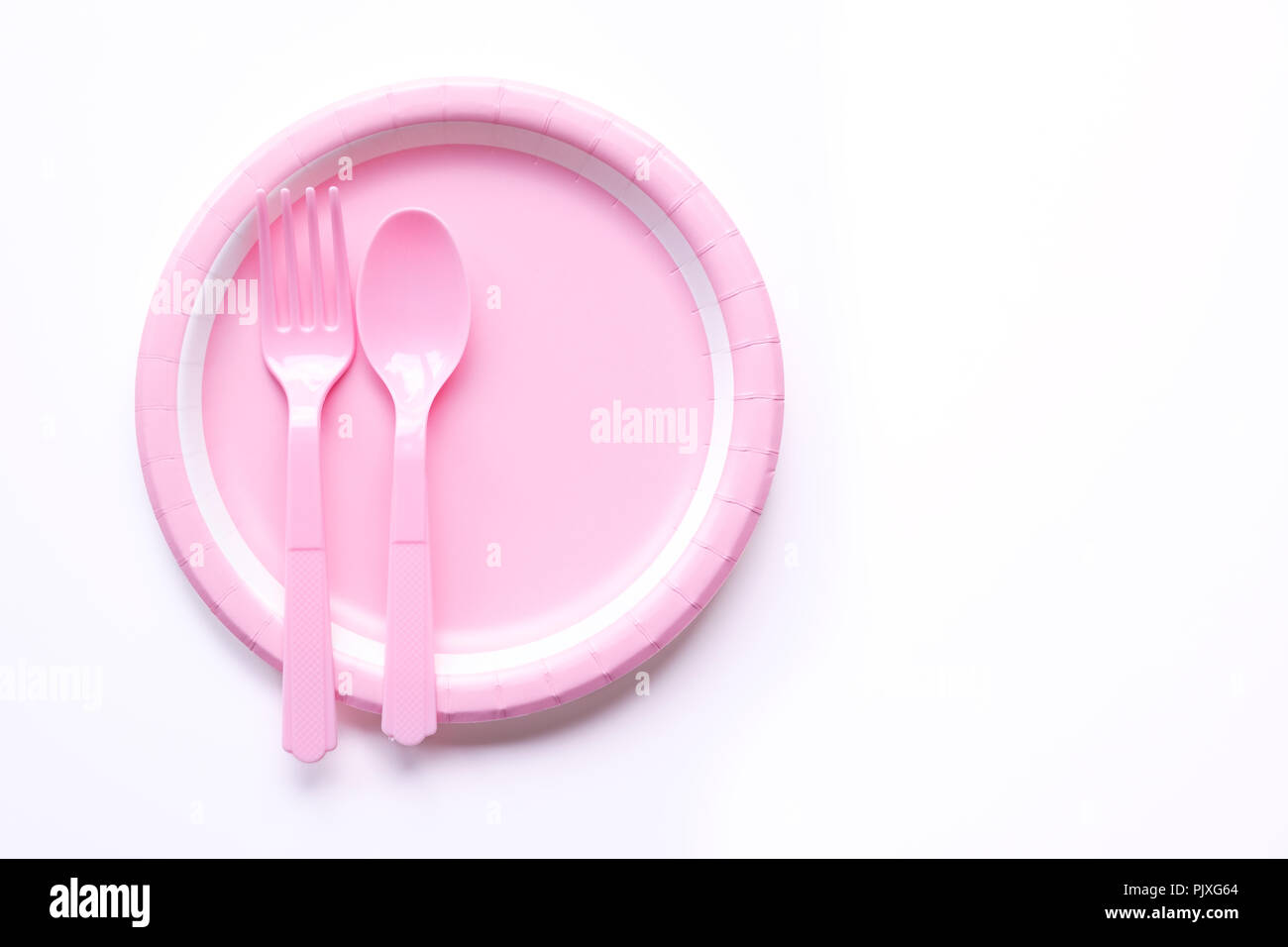 Pink color paper plate with spoon and fork Stock Photo