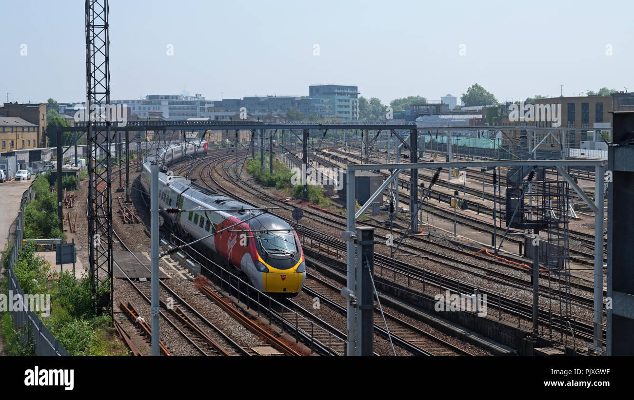 London, England - May 28, 2018: A Virgin Rail Group passenger train heading north at Primrose Hill, a short distance outside Euston railway station Stock Photo