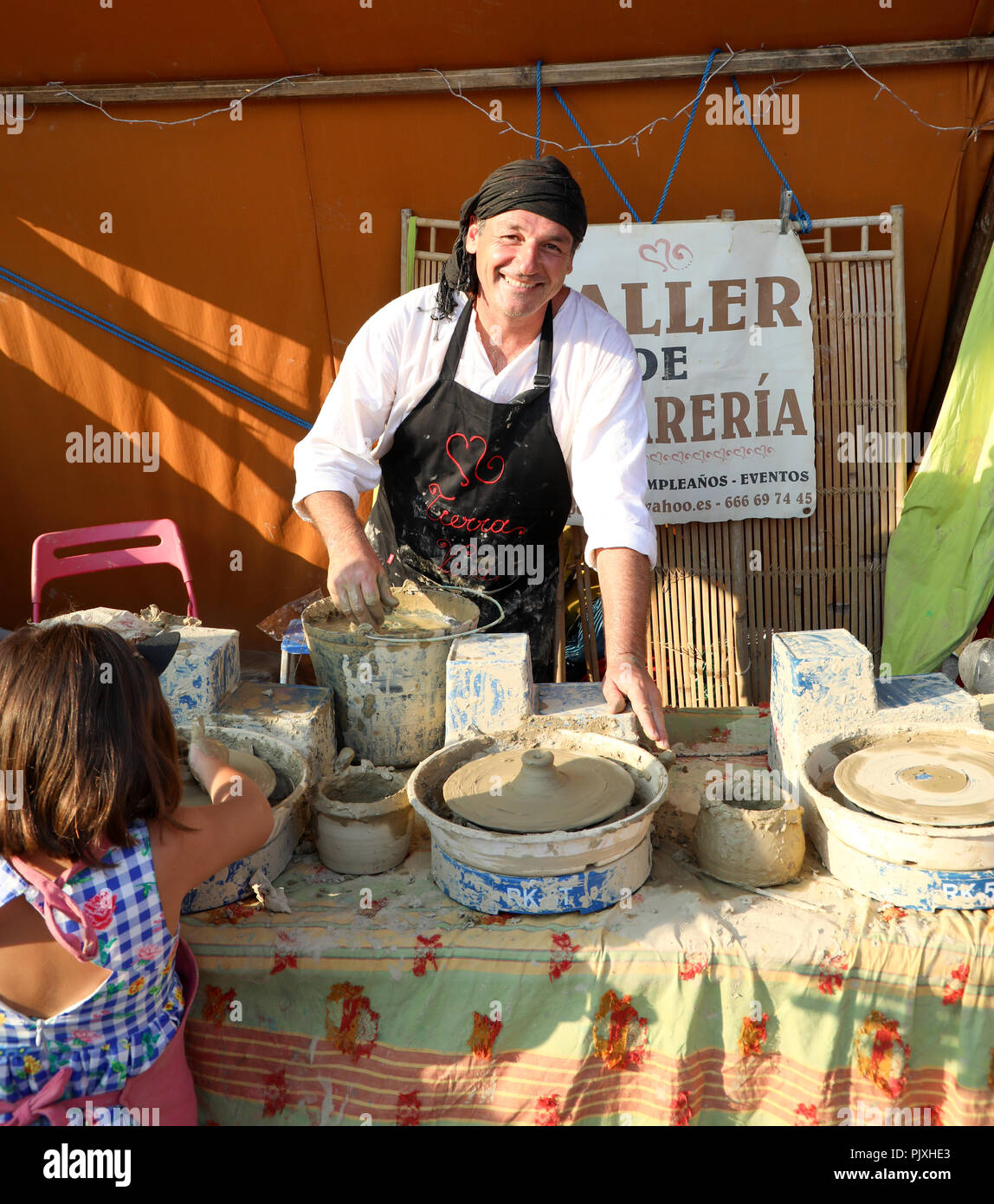 Potter working at a Spanish fiesta Stock Photo