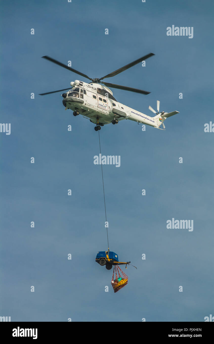 Rescue helicopter bringing supplies to the ship run aground on Sheffield Beach, near Durban, South Africa. Stock Photo