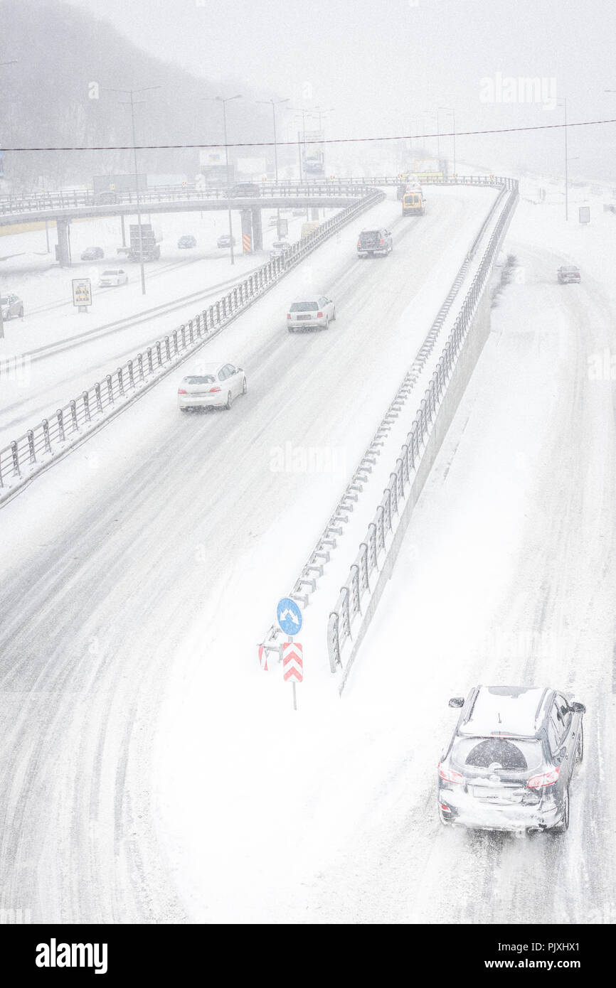 Snow storm on the roads in December in Kiev, Ukraine. Snowy and nothing visibility on the street