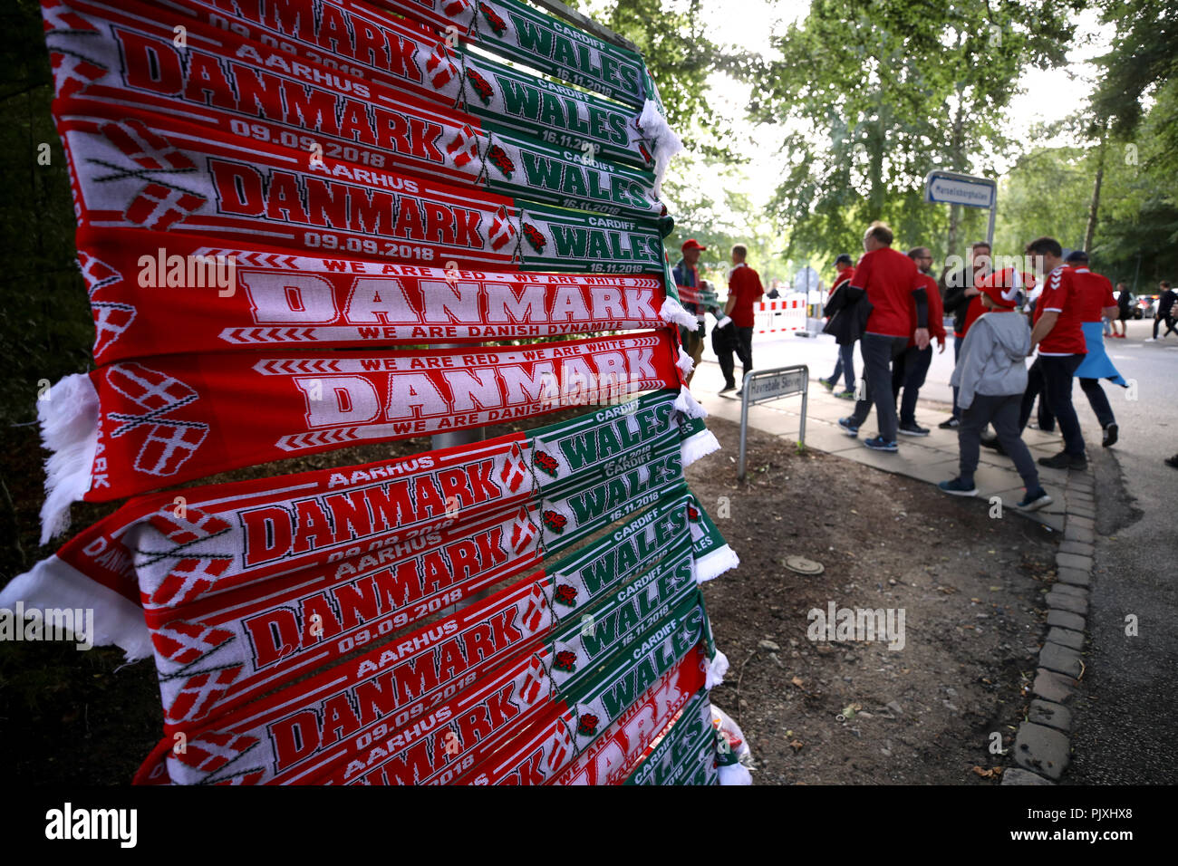 Wales fans make their way to the stadium past a stall selling match half and half scarves before the Nations League, League B Group four match at Ceres Park, Aarhus. Stock Photo