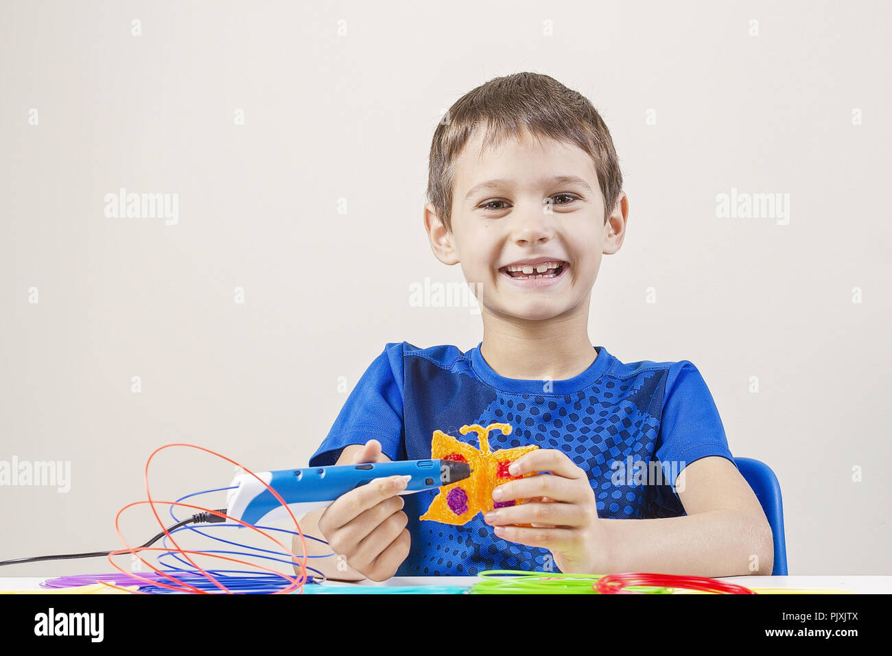 Child creating with 3d printing pen Stock Photo - Alamy