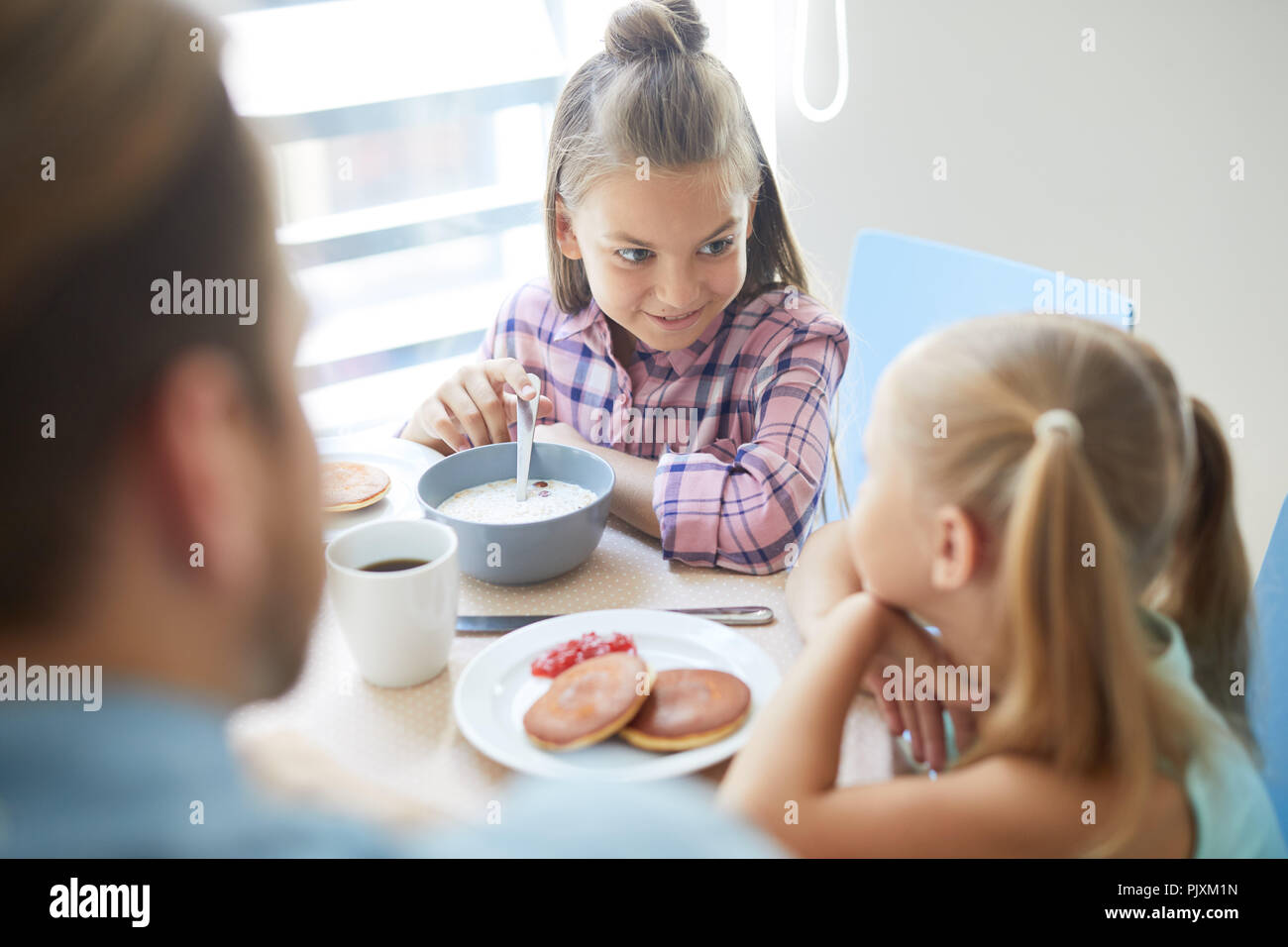 Sisters by breakfast Stock Photo - Alamy