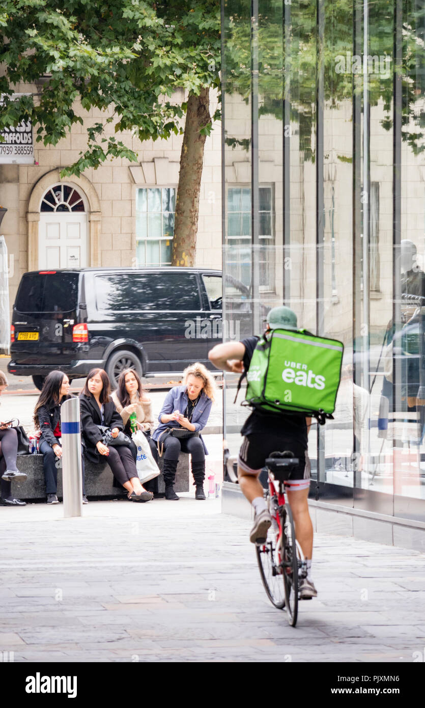 Uber Eats delivery boy collecting his bike, Bristol, England, UK Stock Photo