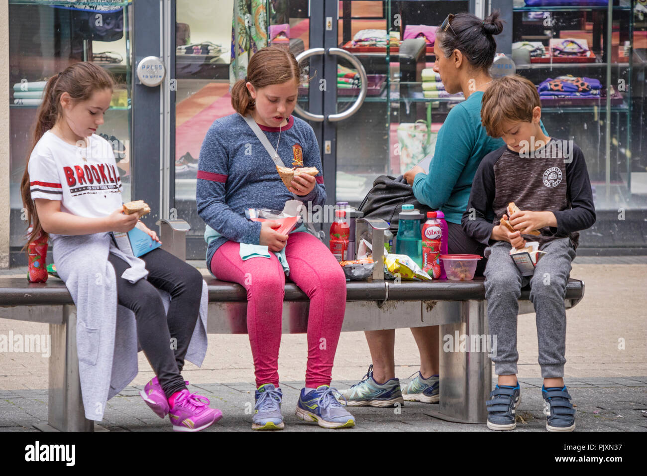 Children eating shop bought fast food while shopping in Bristol, England, UK Stock Photo