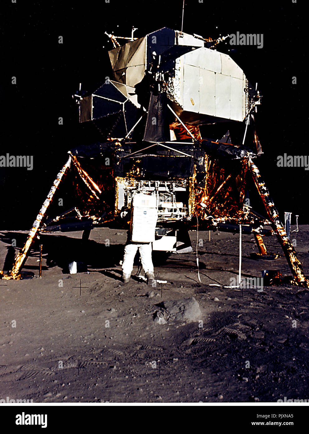 The Moon - (FILE) -- Man's first landing on the Moon was accomplished at 4:17 p.m. on Sunday, July 20, 1969 as Lunar module "Eagle" touched down gently on the Sea of Tranquility on the east side of the Moon. Astronaut Edwin E. Aldrin Jr., Lunar Module Pilot, removes scientific experiment packages from a stowage area in the Lunar Module's descent stage. Left behind on the lunar surface by Aldrin and Neil A. Armstrong, Apollo 11 Commander, were a Passive Seismic Experiments Package and a Laser Ranging Retro Reflector.  Credit: NASA / CNP /MediaPunch Stock Photo