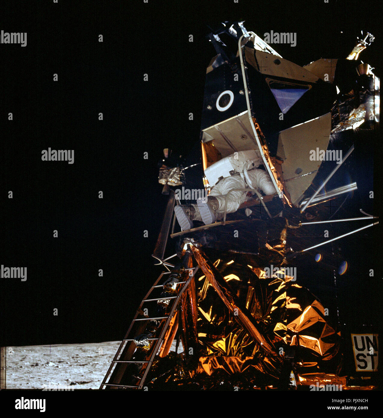 The Moon - (FILE) -- Apollo 11 Lunar Module pilot Edwin Aldrin begins backing out of the hatch to begin his walk on the Moon. Neil Armstrong, who took the first step on the Moon 19 minutes earlier, photographs the scene from the surface.  Credit: NASA via CNP /MediaPunch Stock Photo