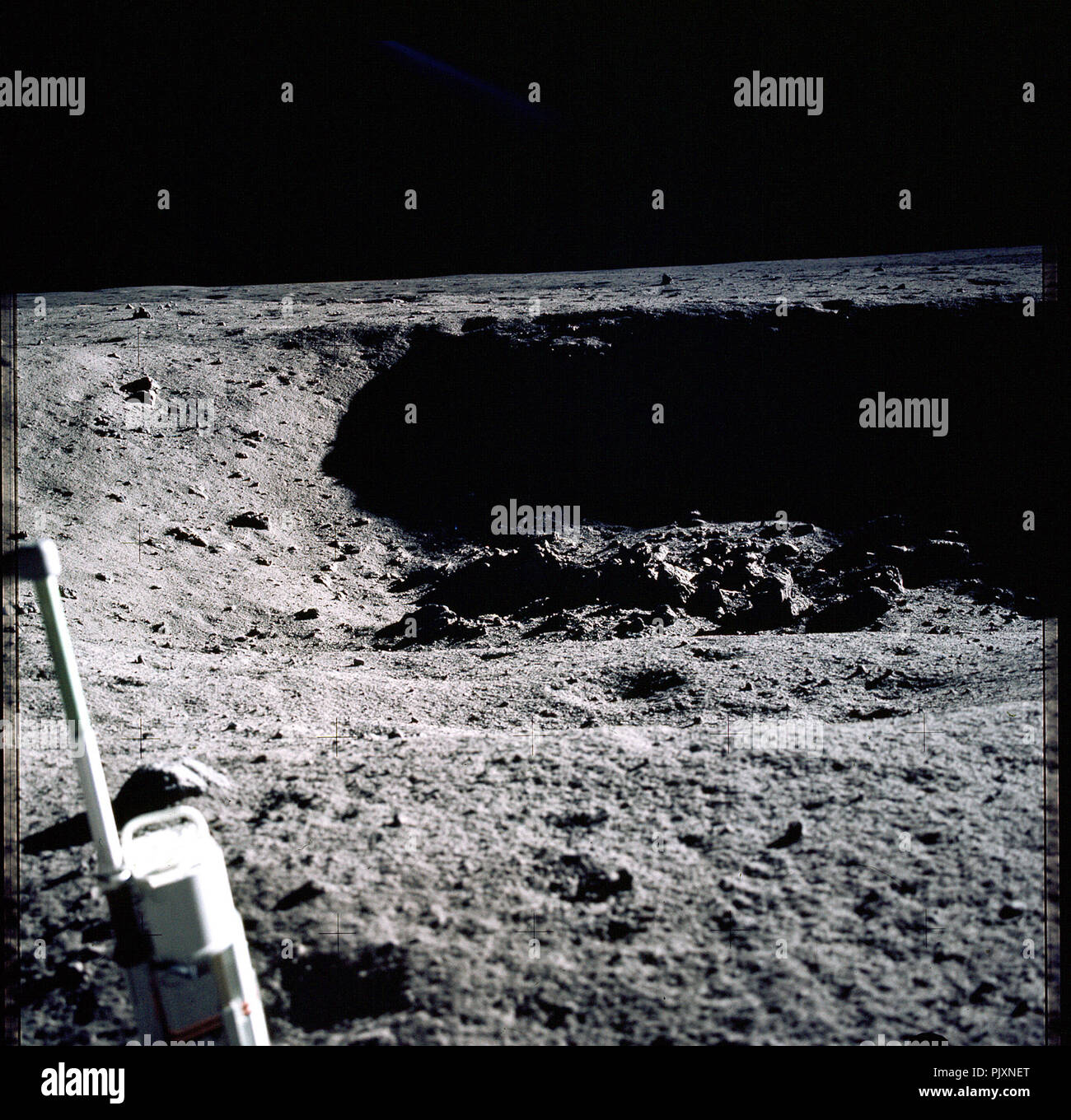 The Moon - (FILE) -- This is a photograph taken by Apollo 11 astronaut Neil Armstrong looking into East Crater, about 60 meters away from the lunar module. He estimated the crater was about 20 to 25 meters in diameter and 4 1/2 to 6 meters deep. The crater wall in the background is in deep shadow. The object at lower left is the stereo close-up camera. The view is roughly towards the northeast.  Credit: NASA via CNP /MediaPunch Stock Photo