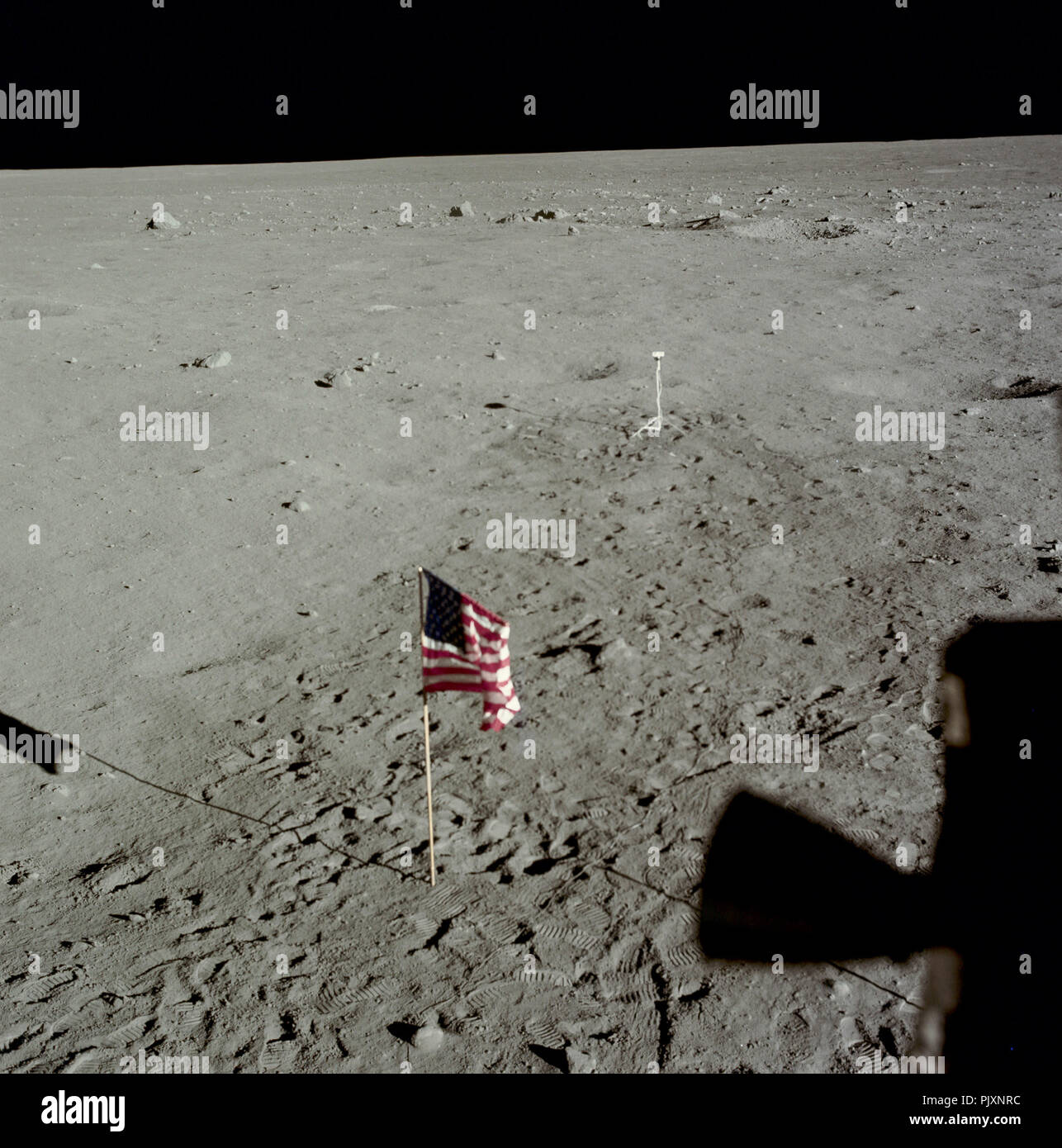 The Moon - (FILE) -- View of lunar surface after Extra Vehicular Activity (EVA) completion on Monday, July 21,1969 with the United States flag and TV camera. Note the difference between the darker, heavily disturbed soil around the camera, and the undisturbed light soil where Armstrong and Aldrin did not set foot. Credit: NASA via CNP /MediaPunch Stock Photo
