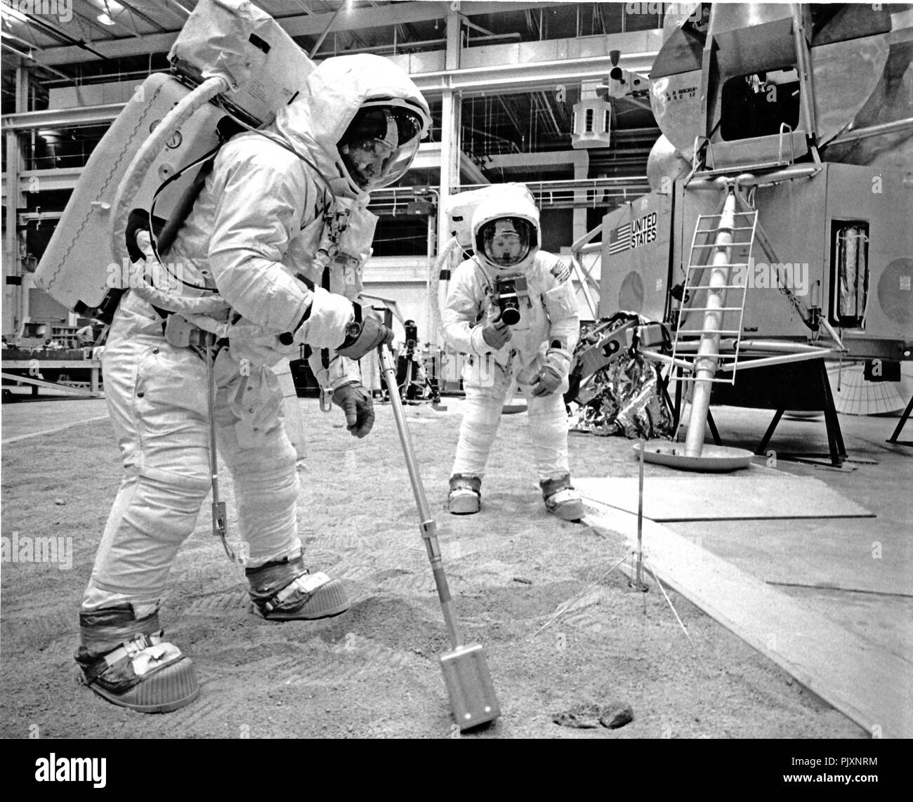 Houston, TX - (FILE) -- Apollo 11 Lunar Module (LM) Pilot Edwin E. 'Buzz' Aldrin, front, and Spacecraft Commander Neil Armstrong, rear, practice lunar surface activities at the Manned Spacecraft Center, Houston, Texas on Friday, April 18, 1969.  Aldrin is using a scoop to collect samples of the surface while Armstrong takes pictures.  The Lunar Module (LM) is in the background.  The astronauts are in space suits.  Breathing oxygen, pressurization and temperature control are provided by backpacks.  Apollo 11 launched on July 16, 1969 and safely returned to Earth on July 24, 1969. Credit: NASA v Stock Photo