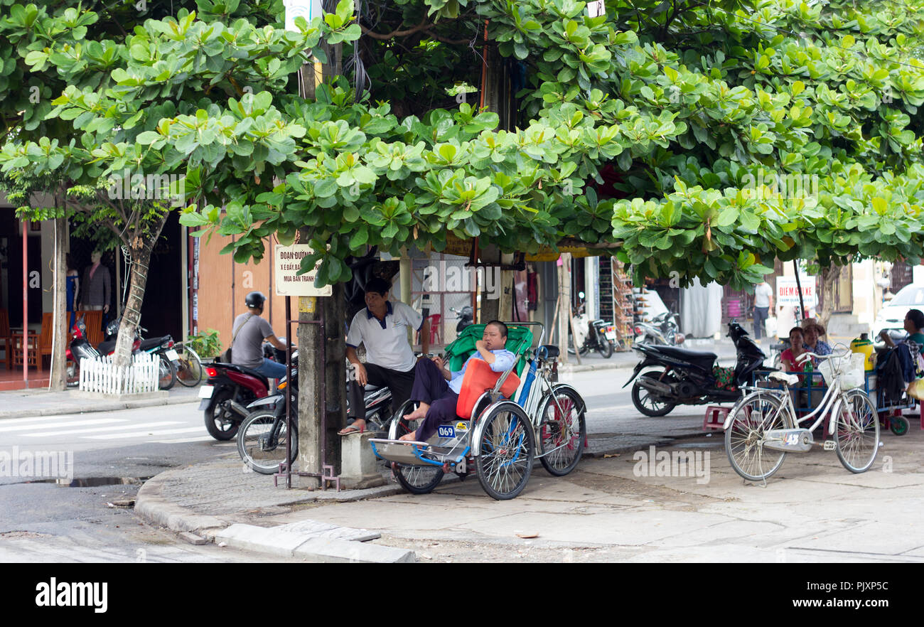 rickshaw drivers waiting for customer on crossroad in Hoi An, Vietnam. Stock Photo