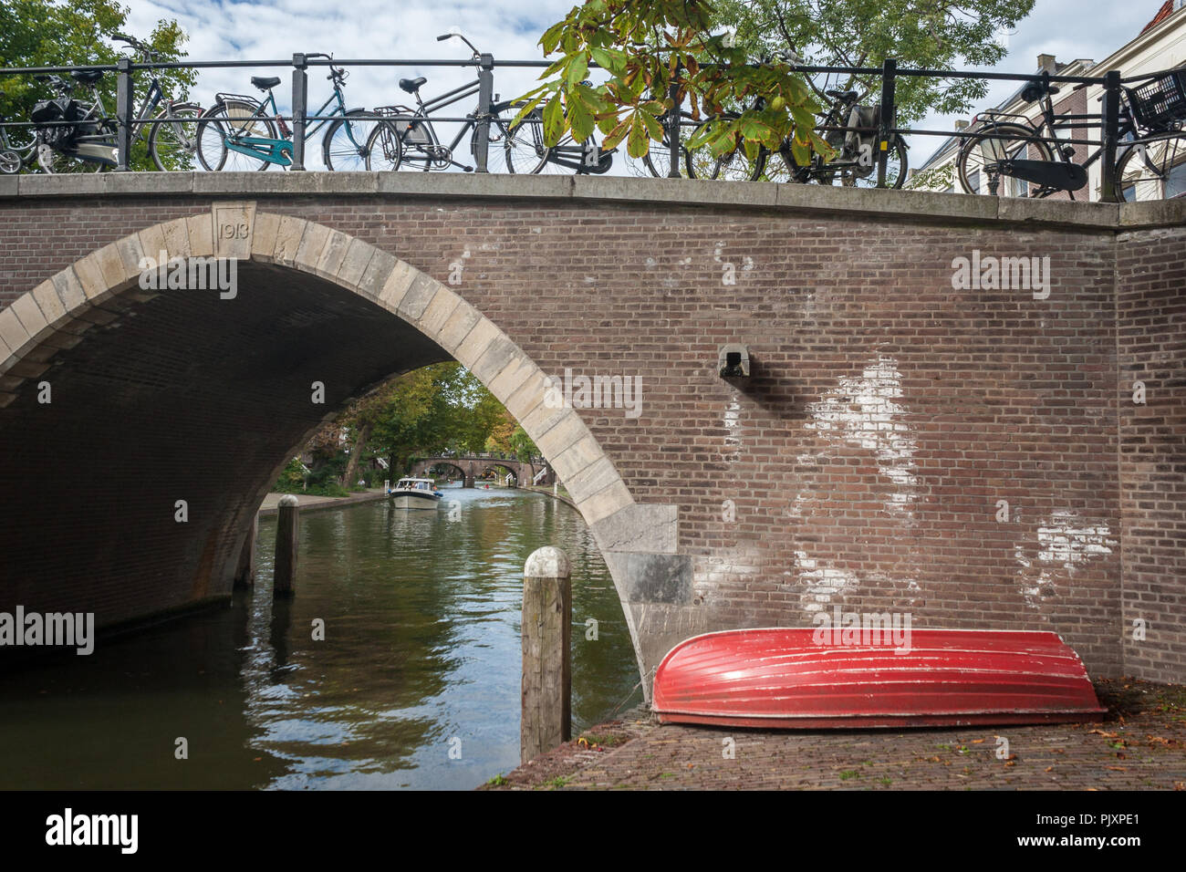 A Red Rowboat Rests On The Banks Of The Oude Gracht In Utrecht