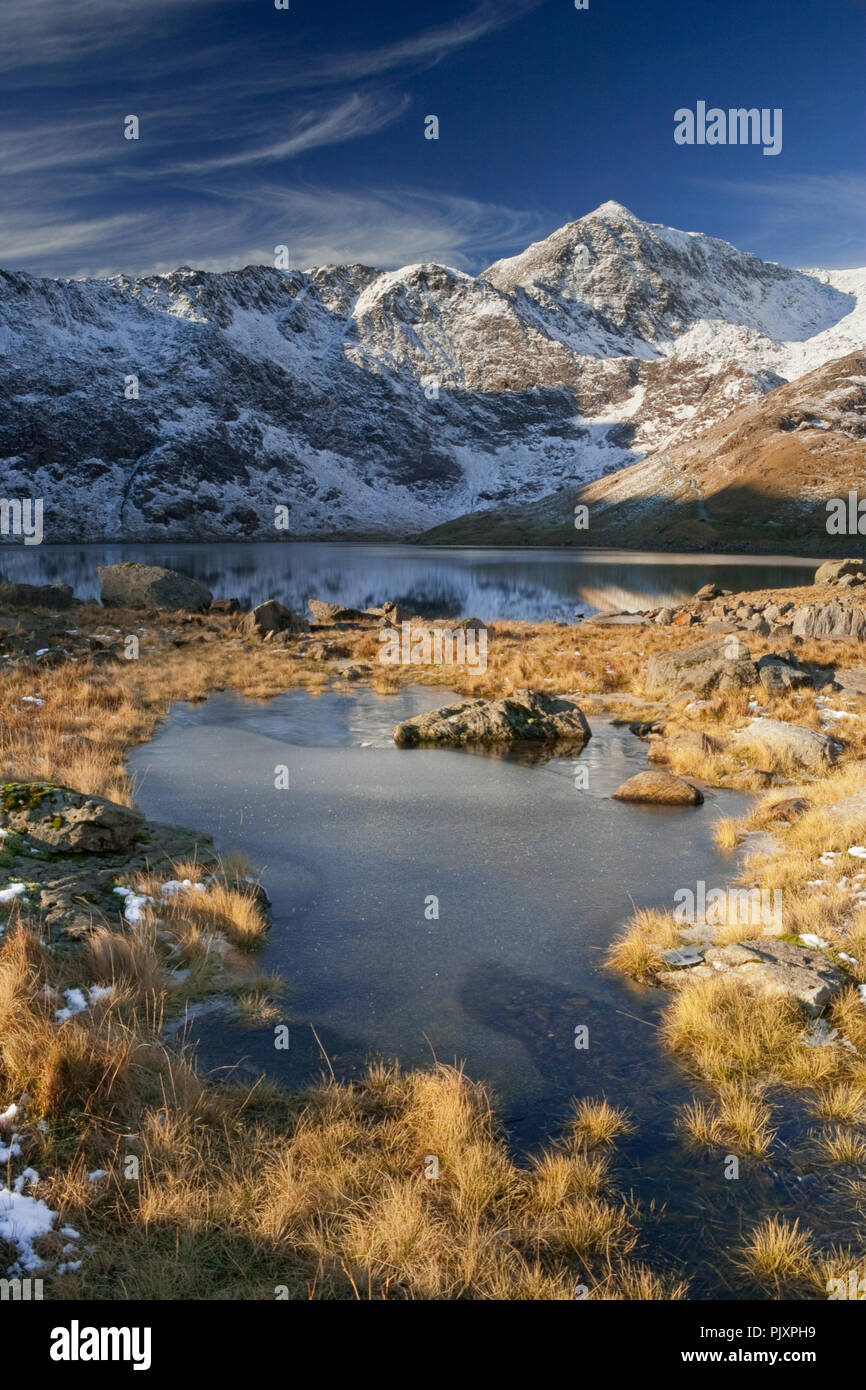 Snowdon mountain in winter, reflecting in the waters of Llyn Llydaw, Snowdonia, North Wales Stock Photo
