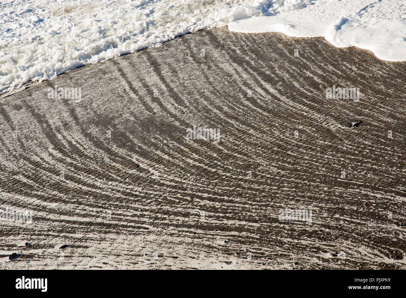 Receding Textures Abstract patterns from receding surf produce a textured background from ...