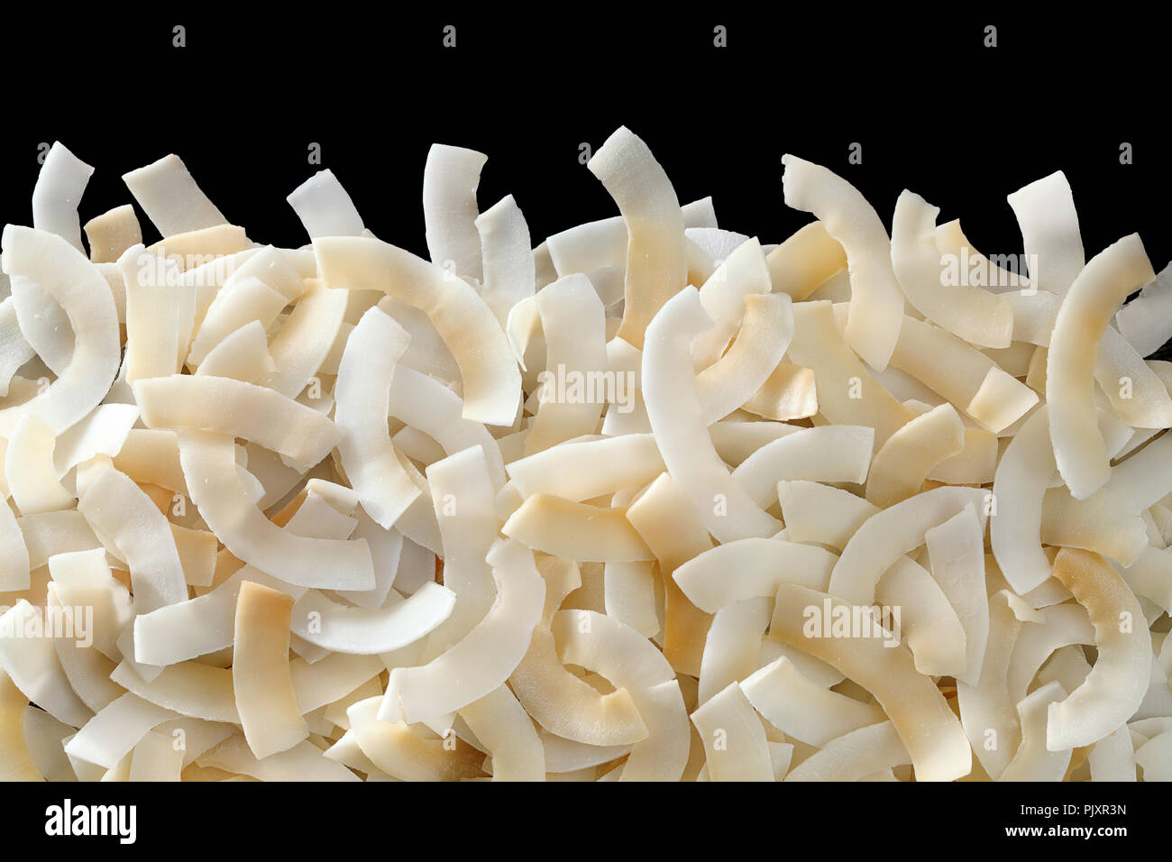 Roasted baked toasted Natural Thin Sliced Coconut Chips Background Stock Photo