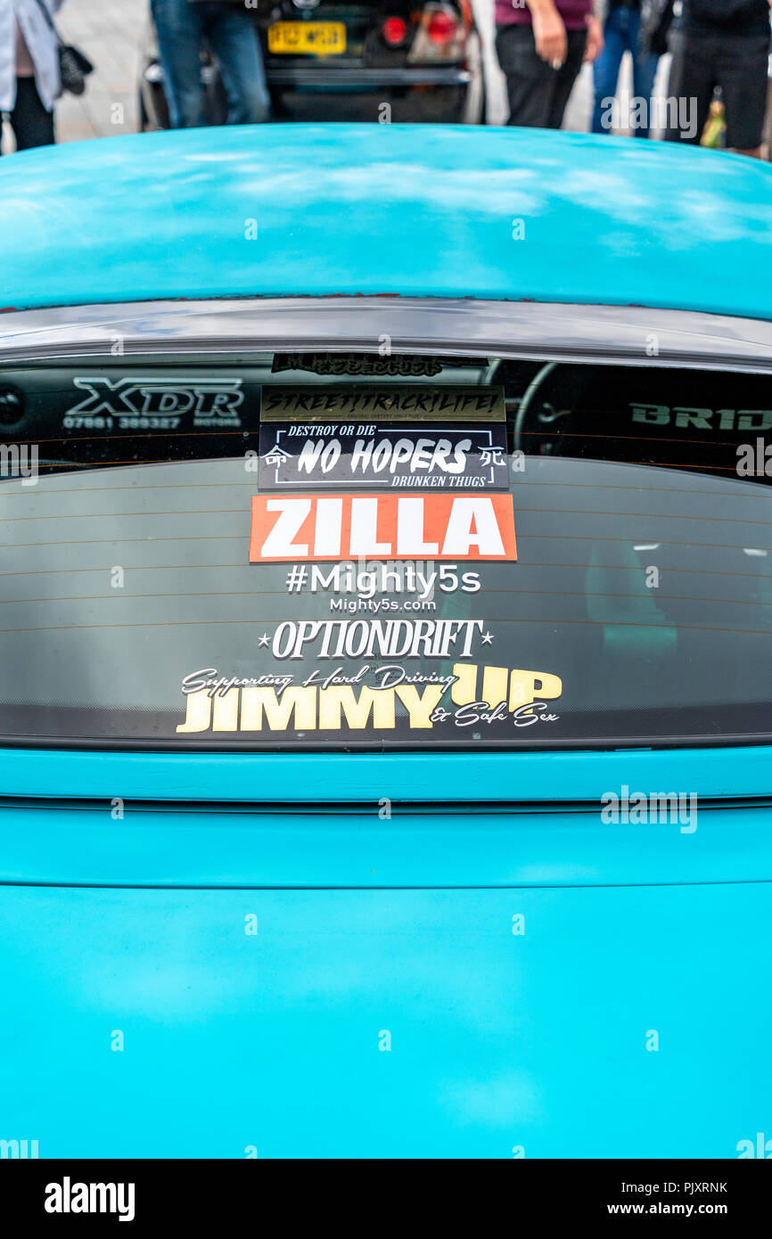 Stickers in back window of blue car Stock Photo - Alamy
