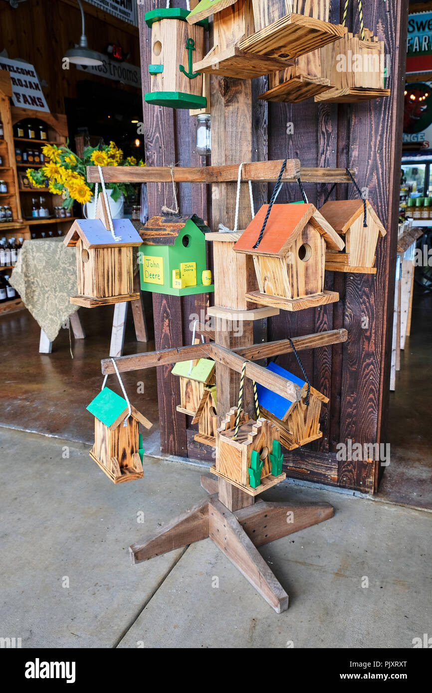 Colorful wooden handmade bird houses for sale at the Sweet Creek country roadside market in Pike Road Alabama, USA. Stock Photo