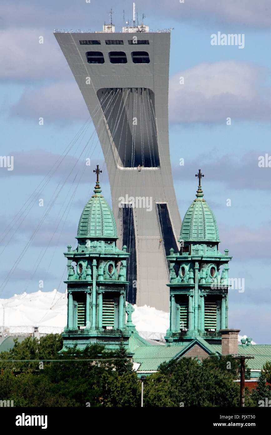 Montreal,Canada, 8 September,2018.The Olympic stadium's tower looming over church steeples.Credit:Mario Beauregard/Alamy Live News Stock Photo