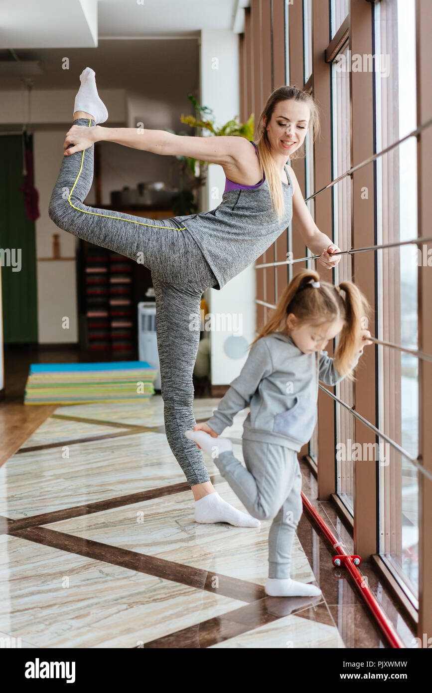 Mom and daughter together perform different exercises Stock Photo Alamy