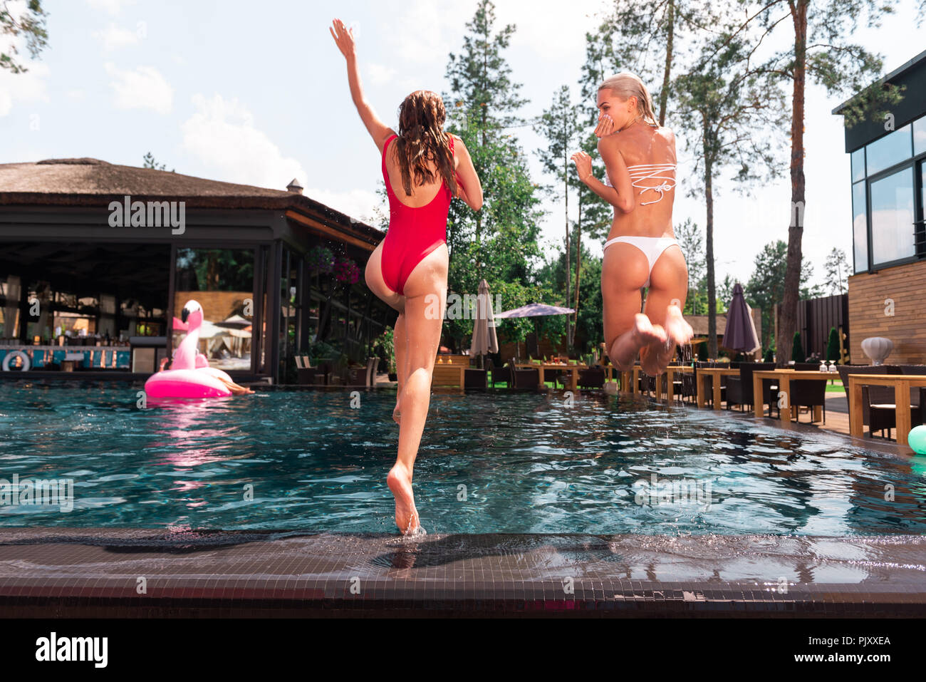 Beautiful attractive women jumping in the water Stock Photo