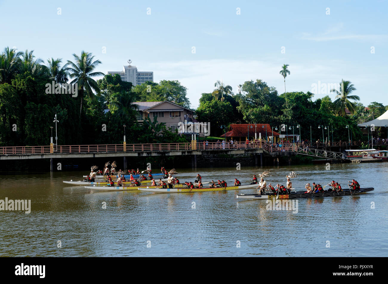 Kuching, Sarawak river, boats with natives in traditional dress form part of the Gawai day parade and celebration Stock Photo