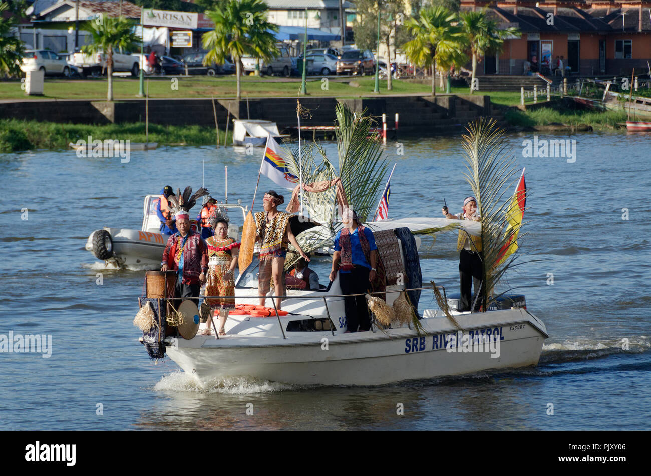 Kuching, Sarawak river, boats with natives in traditional dress form part of the Gawai day