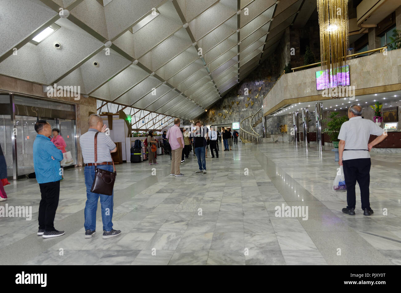 North Korea - Western and Chinese tourists in the foyer of the recption area, Yanggakdo International Hotel, Pyongyang Stock Photo